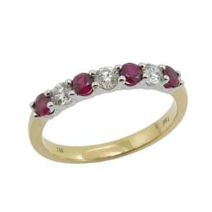 18K Yellow and white gold lady's band claw set with four ruby's, 0.40 total carat weight, and three round brilliant cut diamonds, 0.24 total carat weight, G/H, SI.