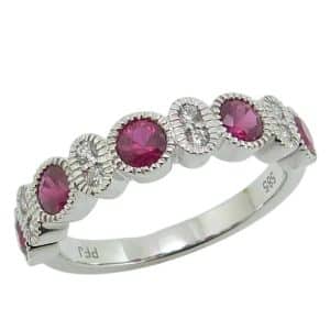14K White gold lady's band bezel set with five ruby's, 0.90 total carat weight, and four round brilliant cut diamonds, 0.11 total carat weight, G/H, SI.