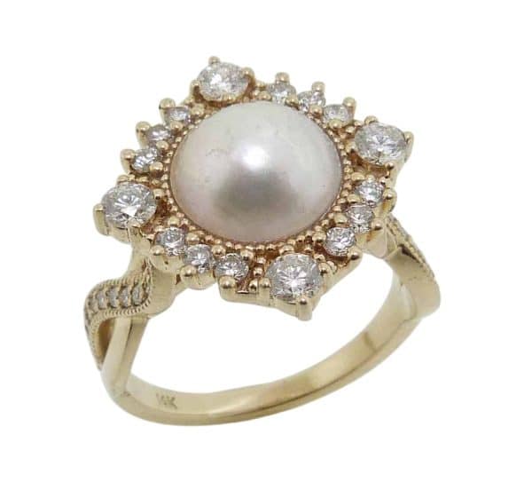 14K Yellow gold custom lady's ring by Studio Tzela set in the centre with a Mabe pearl and accented in the halo with thirty-eight lab grown diamonds, 0.77 total carat weight, F/G, VS+.