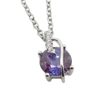 14K White gold Chatham pendant set with a 6.5mm, 1.52 carat round Chatham Alexandrite and accented with 0.03 total carat weight lab grown round brilliant cut diamonds.
