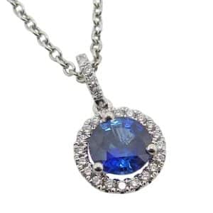 18K White gold halo pendant set in the centre with a 1.001 carat blue sapphire, accented on the bale and in the halo with round brilliant cut natural diamonds, 0.14 total carat weight, G/H, VS-SI1.