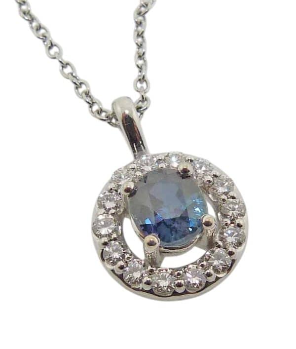 14K White gold halo pendant claw set in the centre with 1.407ct bi-colour Montana sapphire and accented in the halo with fourteen natural, very good cut round brilliant cut diamonds, 0.465 total carat weight, G/H, SI1-2.