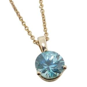 14K Yellow gold three prong set round 1.51 carat blue zircon pendant.