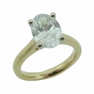 14K Yellow and white solitaire engagement ring claw set with a 2.01 carat, E, VVS2, oval brilliant cut, lab grown diamond.