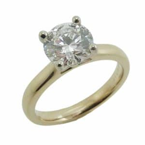 14K Yellow and white gold cathedral solitaire engagement ring claw set with a 1.57 carat, D, VVS2 round brilliant cut lab grown diamond.