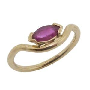 14K Yellow gold curved lady's band V-tip set in an east-west orientation with a 0.40 carat marquise ruby.