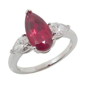 14K White gold ring with claw set in the centre with 2.56 carats (12x6mm) pear Chatham lab grown ruby and accented on the sides with two lab grown pear brilliant cut diamonds totaling 0.77 carats.