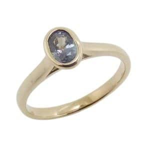 14K Yellow gold lady's ring bezel set with an oval Alexandrite, 0.657 carat.