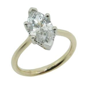 14K Yellow and white gold solitaire engagement ring claw set with a 1.54 carat, D, VVS2 marquise brilliant cut lab grown diamond.