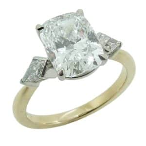 14K Yellow and whtie gold custom engagement ring claw set with a 3.08 carat, D, VVS2 elongated cushion lab grown diamond and accented with two kite cut lab grown diamonds, 0.44cttw, D/E, VVS-VS.