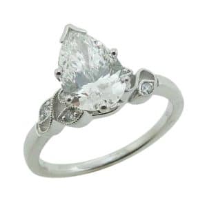 14K White gold Allison Kauffman vintage inspired solitaire engagement ring claw set in the centre with a 1.56 carat, D, VVS2 pear shape lab grown diamond and accented on the band with 0.07cttw natural round brilliant cut diamonds, G/H, SI.