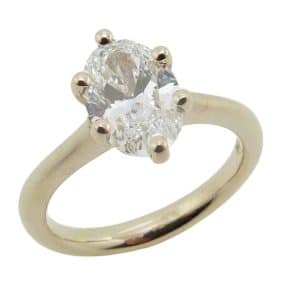 14K Yellow gold petal accented six prong solitaire engagement ring claw set with 1.78 carat, D, VVS2 oval lab grown diamond.