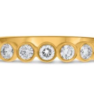 14K Yellow gold bezel set band with eleven round brilliant cut diamonds, 0.50cttw.