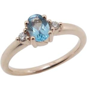 14K Rose gold lady's ring set with a 0.455 carat blue topaz and accented with two natural round brilliant cut diamonds, 0.08cttw, G/H, SI1-2.