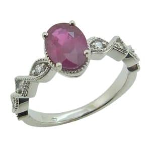 14K White gold lady's ring claw set in the centre with a 1.225 carat oval ruby and accented on the band with six natural round brilliant cut diamonds, 0.105cttw, G/H, SI.