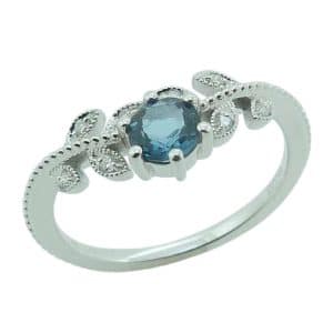 14K White gold milgrain accented leaf accented lady's ring bead set with a round 0.45 carat London blue topaz and accented with eight round brilliant cut diamonds, 0.06cttw.