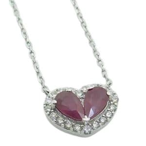 14K White gold ruby halo heart pendant on chain claw set with two pear shape ruby's, 0.50 total carat weight, twenty round brilliant cut diamonds, 0.11 total carat weight.