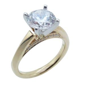 14K Yellow and white gold solitaire engagement ring set in the centre with a 2 carat round CZ and accented in the bridge with pave set round brilliant cut diamonds, 0.08cttw.
