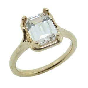 14K Yellow gold claw set "bezel" solitaire small split shank engagement ring with a 2.0 carat emerald cut CZ.