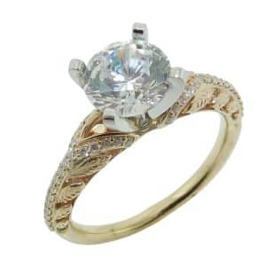 14K Yellow and white gold solitaire engagement ring claw set in the centre with a 1.5 carat CZ and 0.19 total carat weight round brilliant cut diamonds pave set in the with open leaf accented band.