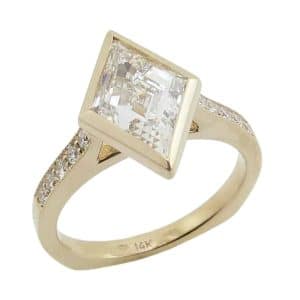 14K Yellow gold custom engagement ring bezel set with a 2.00 carat E, VVS2 lozenge step cut lab grown diamond, accented on the band with ten pave set round brilliant cut lab grown diamonds, 0.181cttw.