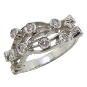 Estate item -  14KW dinner ring with milgrain and filigree details bezel set with twelve round brilliant cut diamonds, 0.40cttw.