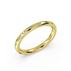 14K Yellow gold diamond band by Sylvie Jewelry claw set in a spread out style with nine round brilliant cut diamonds totaling 0.08 carats.