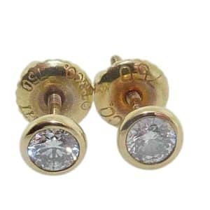 Estate 18K yellow gold Tiffany & Co bezel set diamond studs with screw backs set with two round brilliant cut, 0.50 total carat weight, H/I, SI.