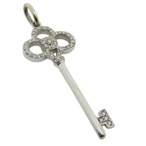 Estate 18K White gold Tiffany & Co key pendant set with round brilliant cut natural diamonds, 0.20 total carat weight, SI.