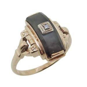Estate item - 10K Yellow gold lady's ring with an onyx and a 0.01 carat single cut diamond.