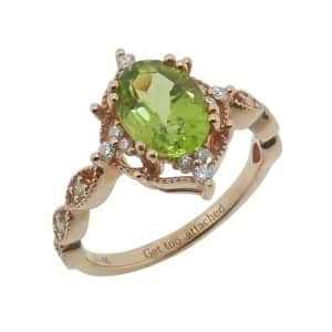 Estate item - 14K Rose lady's ring claw set with 1.35 carat oval peridot accented with eighteen round brilliant cut diamonds, 0.15cttw.