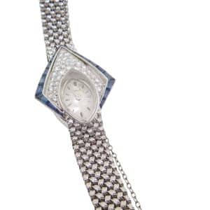 Estate item - 18K White gold Piaget lady's watch with a sapphire crystal accented with tapered baguette blue sapphires and forty full cut and single cut diamonds - note needs to be worn on a small wrist.