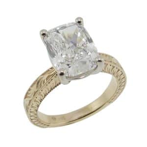 14K Yellow and white gold vintage inspired milgrain accented solitaire engagement ring claw set with a 3.74 carat, E, VVS2 cushion modified brilliant lab grown diamond.