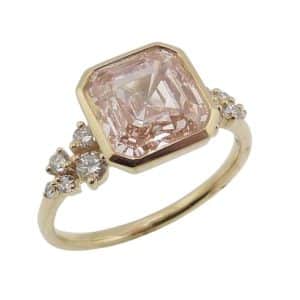 14K Yellow gold engagement ring bezel set in the centre with a fancy intense pink square emerald cut (Asscher) lab grown diamond, 3.08 carat, VS1, and accented on the sides with ten claw set round brilliant cut lab grown diamonds, 0.12cttw, D-F, VS.