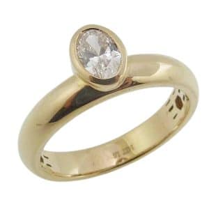 14K Yellow gold offset lady's ring bezel set with an oval brilliant cut lab grown diamond, 0.50 carat, D-F, VS.