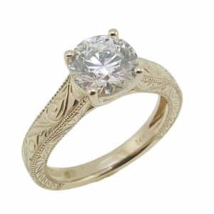 14K Yellow gold vintage inspired trellis engagement ring set with a 1.54 carat, D, VVS2 round brilliant cut lab grown diamond.