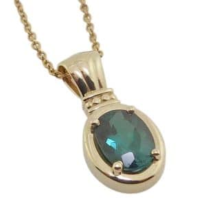 14K Yellow gold oval 1.38 carat blue-green tourmaline pendant.