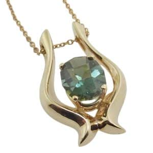 14K Yellow gold pendant claw set with 2.16 carat special cut oval blue-green tourmaline.