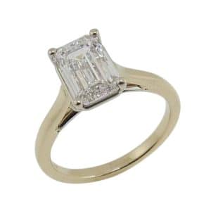 14K Yellow and white gold engagement ring claw set with a 2.12 carat, D, VVS1 emerald cut lab grown diamond.