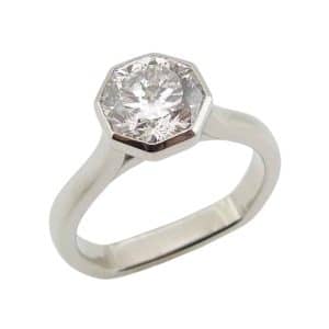 Platinum solitaire engagement ring bezel set with a 1.69 carat octagonal modified brilliant cut lab grown diamond, D, VVS2.