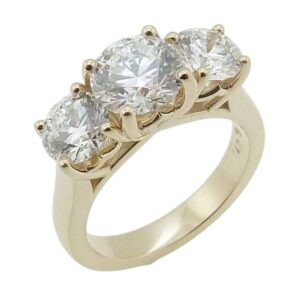 14K Yellow gold three stone engagement ring claw set in the centre with a 0.76 carat, D, VVS2 ideal cut, round brilliant cut lab grown diamond, and accented with two round brilliant cut lab grown diamonds, 0.673cttw, D-F, VVS-VS.