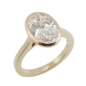 14KY solitaire engagement ring bezel set with a 2.03 carat, D, VVS2 oval brilliant cut lab grown diamond. 