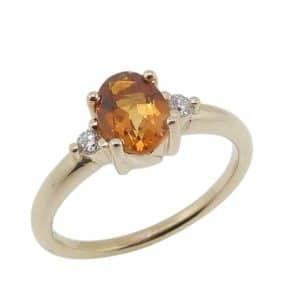 14K Yellow gold lady's ring claw set with a 0.727 carat citrine and two natural very good, round brilliant cut diamond's, 0.065cttw, G/H, SI1-2.