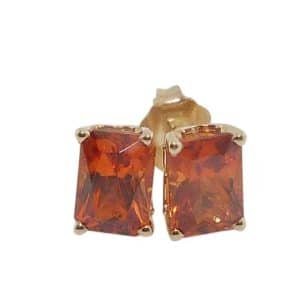 14K Yellow gold stud earrings claw set with two radiant cut spessartite garnets, 2.80 total carat weight.