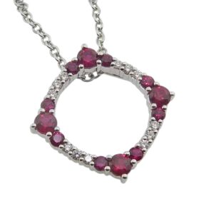 14K White gold open circle pendant claw set with rubies, 0.75cttw, and round brilliant cut diamonds, 0.12cttw.
