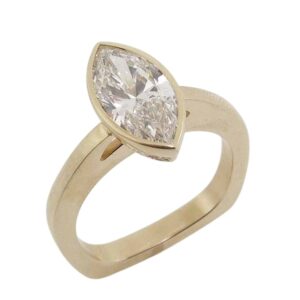 14K Yellow gold Euro shank solitaire engagement ring bezel set with a 1.59 carat, D, VVS2 marquise brilliant cut lab grown diamond, accented in the hidden halo with sixteen round brilliant cut lab grown diamonds, 0.144cttw, F/G, VS+.