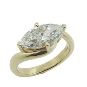 14K Yellow gold engagement ring claw set in an east-west setting with a 1.91 carat, D, VVS2 marquise brilliant cut lab grown diamond.