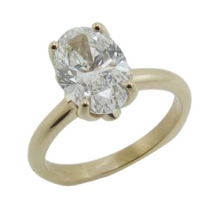 14K Yellow gold solitaire engagement ring with diamond floral petal details in the head set with a 2.10 carat, D, VVS2 oval brilliant cut lab grown diamond. Accented with six round brilliant cut  lab grown diamonds, 0.045cttw, DEF, VVS-VS.
