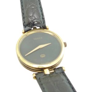 Estate Lady's Gucci watch black dial gold plated round case with leather strap.