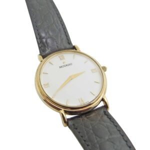 Estate Movado watch with yellow gold plating and black leather strap.